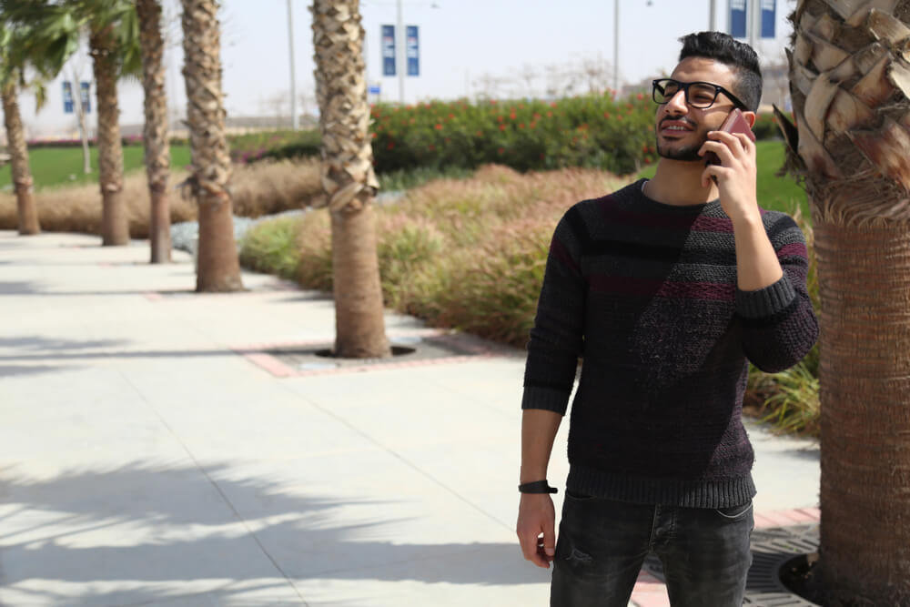 Young man talking on a smartphone outdoors, as mobile communication and everyday digital connectivity in Egypt.